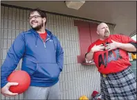  ?? Arkansas Democrat-Gazette/MITCHELL PE MASILUN ?? Zachary Booe (left) of North Little Rock and Mo Sliger of Cabot talk about Margie Ashcraft, a kickball teammate who was killed earlier this year. The team, Team Francis, held a fundraiser for her family before their game at Interstate Park in Little...