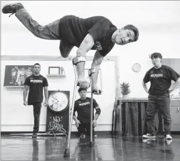  ?? CP PHOTO ?? Luca ‘Lazylegz’ Patuelli of the ILL-Abilities breakdance crew rehearses as Samuel Henrique ‘Samuka’ de Silveira Lima, Sergio ‘Checho’ Carvajal and Jung Soo ‘Krops’ Lee, from left, look on in Montreal on Wednesday. The team of differentl­yabled dancers celebrates its 10th anniversar­y by throwing a one-of-a-kind jam in collaborat­ion with Les Grands Ballets Canadiens de Montreal on Saturday.