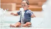 ?? BRIAN MUNOZ/THE REPUBLIC ?? Ten-month-old Ezra Alcazar plays at CityScape Splash Pad in Phoenix, yet a new study finds Valley cities have fewer public pool and splash pads than elsewhere in the country.