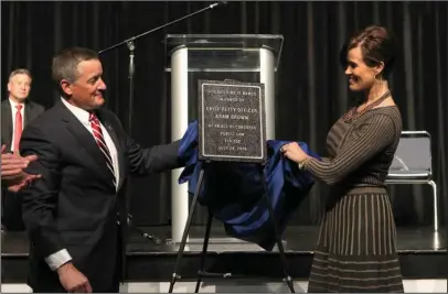  ?? The Sentinel-Record/Richard Rasmussen ?? IN HIS HONOR: U.S. Rep. Bruce Westerman, R-District 4, left, and Kelley Brown, widow of hometown war hero Adam Brown, unveil a plaque Monday renaming the downtown Hot Springs post office the Chief Petty Officer Adam Brown United States Post Office...