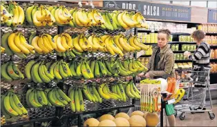  ?? Ap Photo/gene J. Puskar ?? In this May 3 file photo, customers shop at a Whole Foods Market in Upper Saint Clair, Pa. Amazon is moving swiftly to make big changes at Whole Foods, saying it plans to cut prices on bananas, eggs, salmon, beef and more as soon as it completes its...