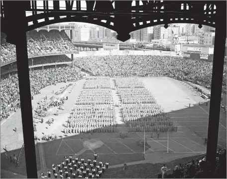  ?? AP FILE PHOTOS ?? Above, West Point Military Academy cadets march into Yankee Stadium on Oct. 29, 1938 before a football game between Army and Notre Dame in New York. Games matching Notre Dame and Army packed Yankee Stadium in the 1920s and ’30s, even during the Great Depression. Below, Jay Berwanger won the inaugural Heisman Trophy in 1934, but eschewed the NFL for a career in a rubber company.