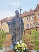  ?? ?? Local lad turned saint: A monument to John Paul II stands across Wawel Cathedral in Krakow.