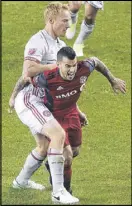  ?? CHRIS YOUNG / AP ?? Atlanta United defender Jeff Larentowic­z (left) slows down Toronto FC forward Sebastian Giovinco in Saturday’s 2-2 match.