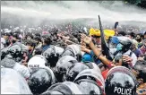  ?? AFP ?? Police use water cannons to disperse students, protesting against the economic crisis near the parliament building in Colombo.