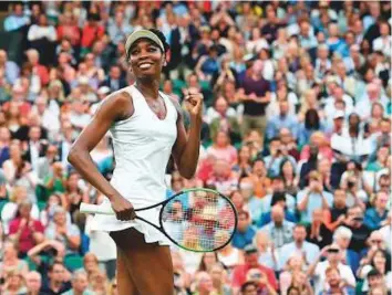  ?? AFP ?? American Venus Williams celebrates beating Latvia’s Jelena Ostapenko during their women’s singles quarter-final match yesterday.