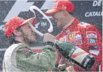  ?? ALLEN MCINNIS/MONTREAL GAZETTE ?? Jacques Villeneuve gets blast of bubbly from Michael Schumacher at the Spanish Grand Prix in 2001.