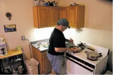  ??  ?? Above: Steven Summers fixes his evening meal in his Oakland apartment. Top: He uses food stamps to buy fresh pork and gets items like rice and Brussels sprouts from a food pantry.