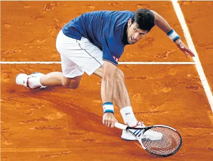  ??  ?? Novak Djokovic returns the ball to Feliciano Lopez during their third round match on Thursday.