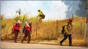  ?? Signal file photo ?? A camp crew works on a fire near Sierra Highway in 2018. Fire officials are preparing for what could be a particular­ly difficult fire season.