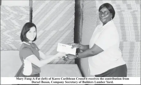  ?? ?? Mary Fung-A-Fat (left) of Kares Caribbean CrossFit receives the contributi­on from Dorsel Bosan, Company Secretary of Builders Lumber Yard.