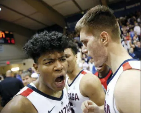  ?? MARCO GARCIA — THE ASSOCIATED PRESS ?? Gonzaga’s Rui Hachimura, left, and Filip Petrusev (3) celebrate after the Bulldogs defeated Duke, 89-87, to win the Maui Invitation­al on Wednesday, Nov. 21. Gonzaga jumped to No. 1 in the AP Poll this week.