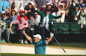  ?? ?? The Associated Press
Rory McIlroy, of Northern Ireland, reacts after holing out from the bunker for a birdie during the final round at the Masters golf tournament on April 10 in Augusta, Ga.