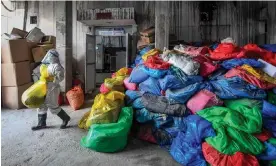 ?? Photograph: Prakash Mathema/AFP/Getty Images ?? A worker at a hospital in Kathmandu, Nepal, readies bags of Covid-19 waste for treatment, December last year.