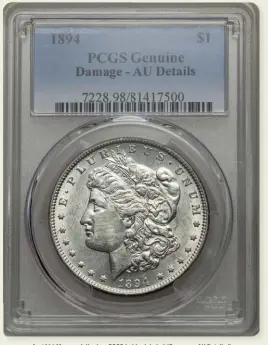  ?? Photo courtesy Heritage Auctions. ?? An 1894 Morgan dollar in a PCGS holder labeled “Damage - AU Details.”