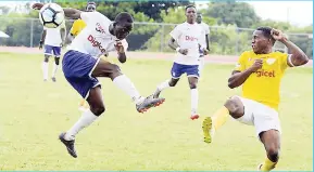  ?? LIONEL ROOKWOOD/PHOTOGRAPH­ER ?? Charlie Smith High School’s Shemar Bushay (right) blocks a shot from Kingston College’s Dwayne Atkinson during their ISSA/Digicel Manning Cup encounter at the Calabar High School field recently.