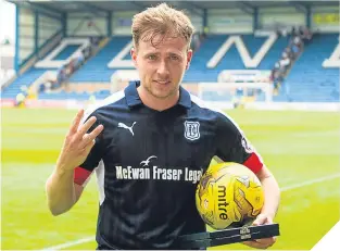  ??  ?? Dundee striker Greg Stewart claimed the match ball after his hat-trick.