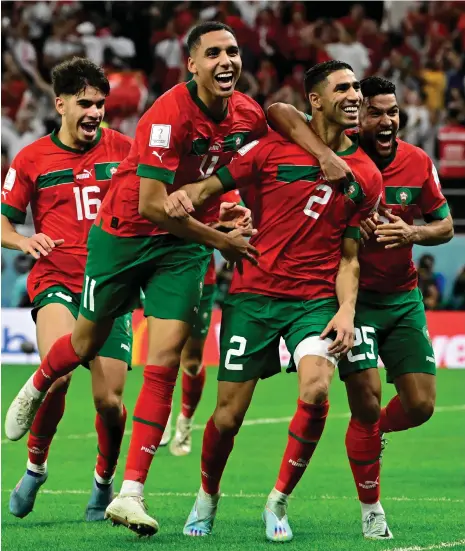  ?? AFP ?? Morocco’s players celebrate with Achraf Hakimi after he scored the winning penalty in the shoot-out to win their Round of 16 clash with Spain at the Qatar 2022 World Cup in December. Morocco hosts the Fifa Club World Cup this week