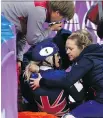  ?? LEAH HENNEL ?? Elise Christie of Great Britain is helped off the ice after colliding with another skater in the short track 1500 metres.