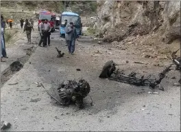  ?? AP PHOTO ?? Police officers examine the site of a suicide bombing at a highway in Shangla district in the Pakistan's Khyber Pakhtunkhw­a province on Tuesday.