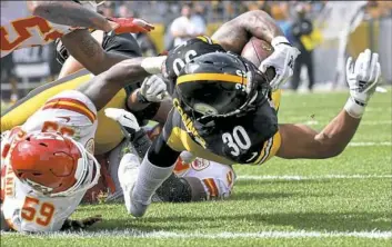  ?? Matt Freed/Post-Gazette ?? Steelers running back James Conner scores a touchdown against the Kansas City Chiefs in the third quarter Sunday at Heinz Field.