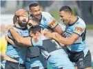  ?? Photo / Getty Images ?? Aaron Woods celebrates scoring for the Sharks.