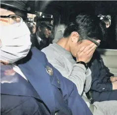  ??  ?? File photo shows suspect Shiraishi (centre) covering his face with his hands as he was transporte­d to the prosecutor’s office from a police station in Tokyo. — AFP photo