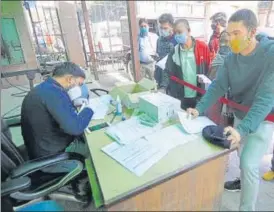  ?? SUNIL GHOSH/HT PHOTO ?? A health worker registers people for a Covid-19 test in Noida.