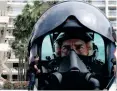  ?? Top Gun: Maverick, Reuters ?? WORKERS clean a platform with a giant advertisin­g pilot helmet broadcasti­ng a trailer for the film on the eve of the opening ceremony.