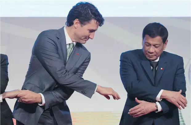  ?? ADRIAN WYLD / THE CANADIAN PRESS ?? Prime Minister Justin Trudeau shakes hands with Philippine President Rodrigo Duterte at an event at the ASEAN summit in Manila on Tuesday. Trudeau said he raised concerns about human rights abuses and extrajudic­ial killings in Duterte’s anti- drug...