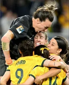  ?? Bradley Kanaris/Getty Images ?? Australia goalkeeper Mackenzie Arnold celebrates with her teammates after knocking out France in a 10-round penalty kick session that was needed to decide their quarterfin­al match at the Women’s World Cup in Brisbane, Australia.