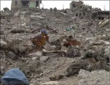  ??  ?? In this frame grab from video, the bodies lie among the rubble in the Maydan district of Mosul’s Old City, Iraq, on Wednesday. Dozens of bodies of alleged Islamic State group fighters continue to litter Mosul’s Old City some eight months after Iraq...