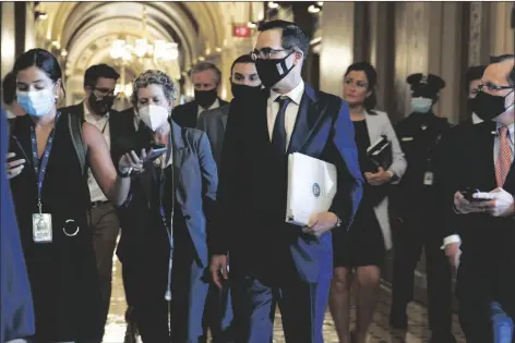  ?? ASSOCIATED PRESS ?? TREASURY SECRETARY STEVEN MNUCHIN (center) walks to a Republican luncheon, Tuesday while attending meetings on Capitol Hill in Washington. In the background at center left is White House Chief of Staff Mark Meadows.