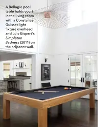  ??  ?? A Bellagio pool table holds court in the living room with a Constance Guisset light fixture overhead and Luis Gispert’s Simpleton Badness (2011) on the adjacent wall.