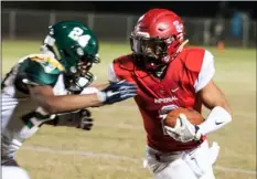  ?? SERGIO BASTIDAS PHOTO ?? Imperial High’s Brandon Hueso (right) gives a stiff arm as he runs the ball against Patrick Henry High in the first round of the CIF-San Diego Section Div. III Playoffs football game on Friday night in Imperial.