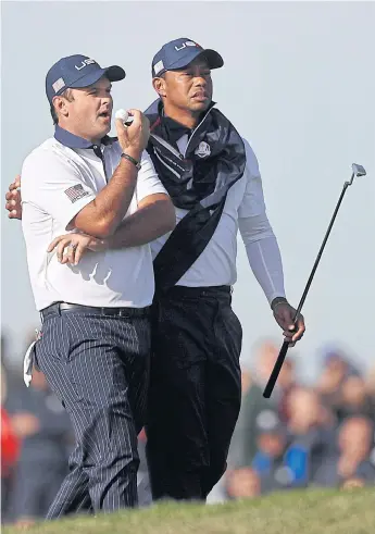  ??  ?? US players Patrick Reed, left, and Tiger Woods.