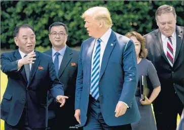  ?? Andrew Harnik Associated Press ?? AFTER his White House meeting with North Korean official Kim Yong Chol, left, President Trump walked back his ambitious goal of rapid denucleari­zation by Pyongyang, saying it would take “a period of time.”