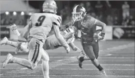  ?? Shotgun Spratling Los Angeles Times ?? JSERRA RECEIVER Tyler Shimomura, right, sheds a tackle while navigating the Santa Margarita defense in the first half of the Eagles’ thrilling victory.