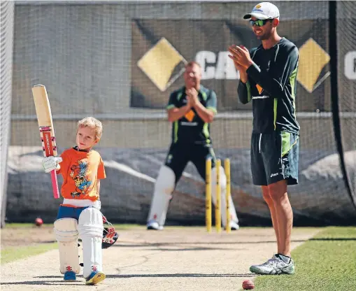  ?? Photo: GETTY IMAGES ?? Father’s footsteps: Zac Haddin, son of Australian wicketkeep­er Brad, raises his bat to acknowledg­e the plaudits of David Warner, left, and Nathan Lyon during practice yesterday before the third test which starts in Melbourne today.