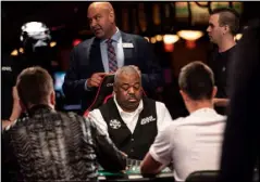  ?? Todd Prince Las Vegas Review-Journal ?? Tournament supervisor Charlie Ciresi, center background, monitors a game being dealt by Daniel Harris at the World Series of Poker at the Rio on July 11.