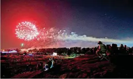  ?? [PHOTO BY BRYAN TERRY, THE OKLAHOMAN ARCHIVES] ?? People watch fireworks in 2016 during the Freedom Fest Tribute to Veterans in Yukon.