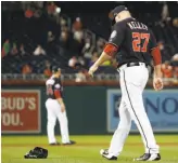  ?? Alex Brandon / Associated Press ?? Washington relief pitcher Shawn Kelley walks to pick up his glove after throwing it after giving up a two-run homer during the ninth inning Tuesday.