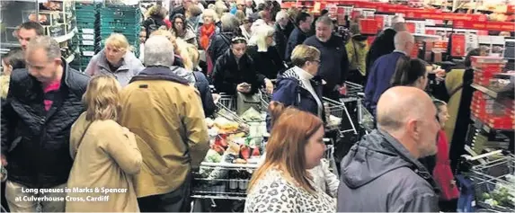  ??  ?? > Long queues in Marks & Spencer at Culverhous­e Cross, Cardiff