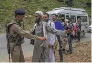  ?? Dar Yasin / Associated Press ?? Indian soldiers frisk a Kashmiri civilian at a temporary checkpoint near a pilgrim camp.