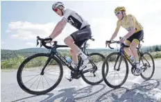  ?? — AFP ?? Great Britain’s Geraint Thomas (R), wearing the overall leader’s yellow jersey, and Christophe­r Froome ride during the 15th stage of the Tour de France.