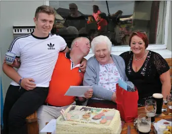  ??  ?? David Flannery had a kiss for his mother-in-law Sabina Hick as he celebrated his 50th birthday at Ventry Regatta, along with his son Nathan and wife Beatrice. Photo by Declan Malone