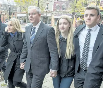  ?? ANDREW VAUGHAN/CANADIAN PRESS ?? Dennis Oland and his wife Lisa, along with family members and friends, head from a bail hearing after being released from custody in Fredericto­n on Tuesday. The New Brunswick Court of Appeal has ordered a new trial in the seconddegr­ee murder conviction...