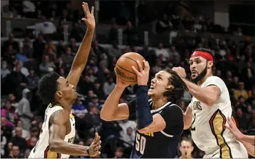  ?? AARON ONTIVEROZ — THE DENVER POST ?? Aaron Gordon, center, of the Nuggets works against Herbert Jones, left, of the Pelicans during the fourth quarter of the Nuggets’ 122-113 win at Ball Arena in Denver on Tuesday.