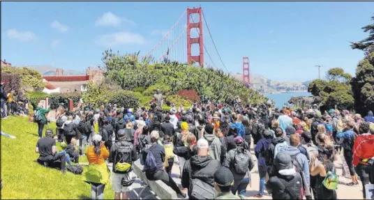  ?? Jeff Chiu The Associated Press ?? Dozens gather by the Golden Gate Bridge Welcome Center on Saturday to show support for the Black Lives Matter movement.