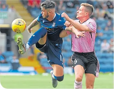  ??  ?? Dundee’s Declan McDaid brings the ball down, closely watched by Peterhead’s Simon Ferry